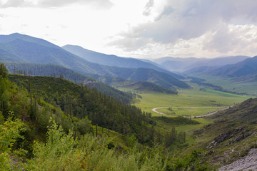 Obraz premium Altai Mountain valley with white clouds. Summer time. Mountain car pass.