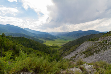Fototapeta na wymiar Altai Mountain valley with white clouds. Summer time. Mountain car pass.