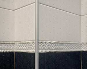 Design of the outer tile corner with a special aluminum corner strip. Example of the professional tile work, close-up view, selective focus