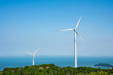 Fototapeta premium Wind turbines in the mountains near the sea