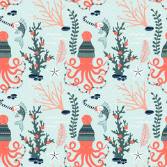 Fototapeta na wymiar Octopus in winter hat with decoration garland Fish with candy Seaweed Coral Starfish decorative Xmas repeatable print. Underwater Christmas seamless vector pattern. Seasonal holidays wrapping paper in