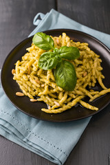 Traditional pasta trofie south of Italy with pesto and basil. Homemade meal for lunch. Copy space.