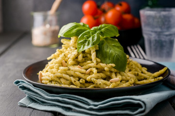 Traditional Italian pasta trofie with basil, garlic, parmesan and olive oil. Homemade food.