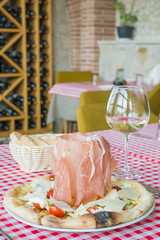 Italian pizza with ham on the table in an Italian restaurant