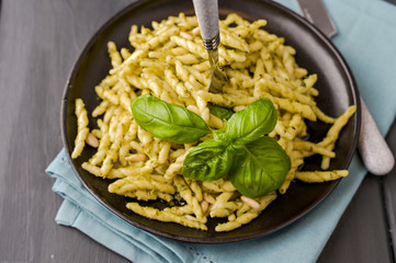 Traditional pasta trofie south of Italy with pesto and basil. Homemade meal for lunch. Copy space.