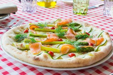 Pizza with salmon cooked in an Italian restaurant