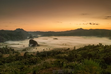 Mountain view morning sea of fog in valley around with forest and many hills with red sun light in the sky background, sunrise at Phu Langka Photo Corner View Point, Route 1148, Phayao, Thailand.