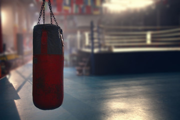 hanging red sanbag in front of boxing ring