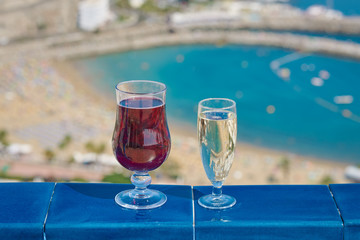 Enjoying the honeymoon. Two wineglasses against the picturesque ocean view.