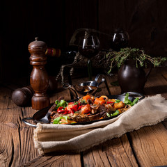 tender beef topped with various vegetables