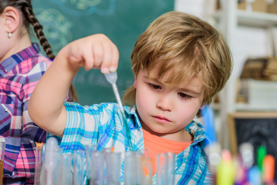 Pupil in chemistry class. back to school. Educational concept. small bopy scientist making experiments in laboratory. School chemistry laboratory. Concentrated boy hardly studying at school.