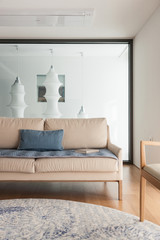 iviry sofa with blanket, cushion at the living room.