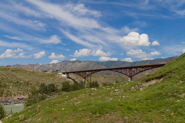 New metal Bridge through the Katun River. Summer sunny time. 