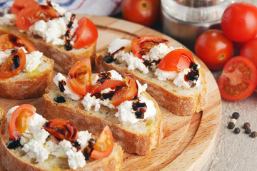 Sandwiches with tomatoes, homemade cheese, olive oil and balsamic sauce