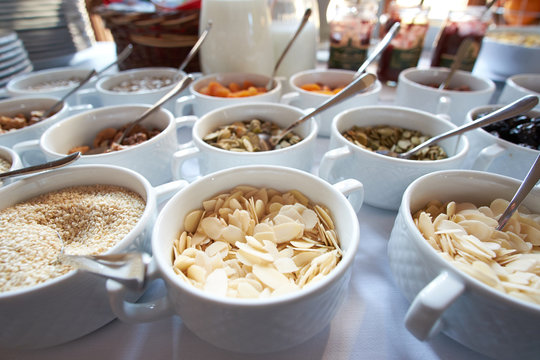 a lot of healthy snack for breakfast of nuts, dried fruits, honey and oats in open buffet