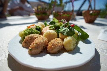 supper set with cauliflower on plate in sunny cafe