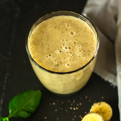 Smoothies, banana, basil, chia seeds and more are healthy food concepts. food background. top view