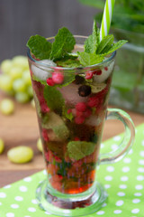 summer cold, ice  fruit tea in glass cup with straw, summer fruit tea drink, wooden background, healthy drink.