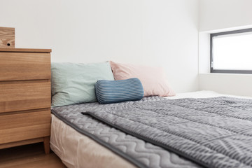 bedroom with tint color pillow and blanket.