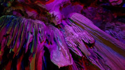 beautiful illuminated multicolored stalactites from karst Reed Flute cave In the cave. Guilin Guangxi China © 一飞 黄