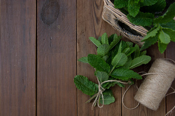 Close up mint leaves on wooden background. Summer drinks or dessert ingredient. Rustic style. Isolated flat lay mint
