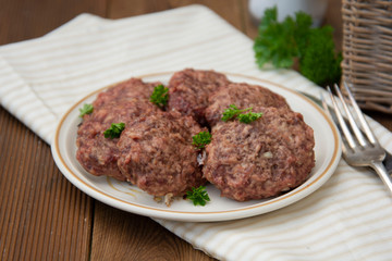 Homemade meat cutlets on a wooden table in a rustic style. Copy space.