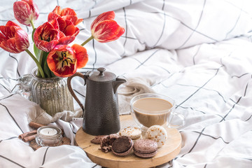 Still life cozy Breakfast with coffee and flowers in the bedroom