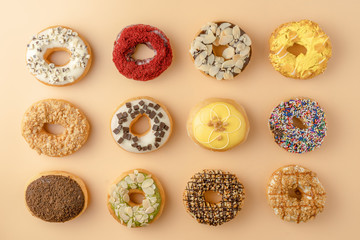 food background of assortment of donuts on orange background