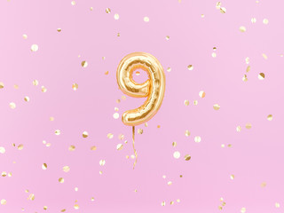 Nine year birthday. Number 9 flying foil balloon on pink. Nine-year anniversary gold confetti background. 3d rendering