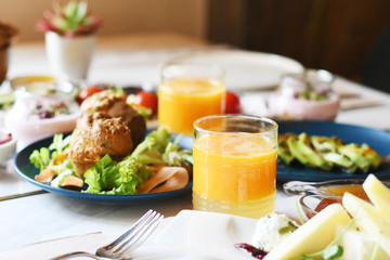 Delicious food served on various plates on a table © Maria Kazanova