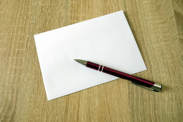 Blank postal envelope with pen