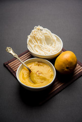 Aam Ras or Alphonso mango pulp with kurdai which is a fried dish made using wheat/gehu. selective focus