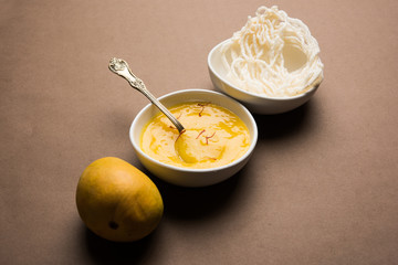 Aam Ras or Alphonso mango pulp with kurdai which is a fried dish made using wheat/gehu. selective focus