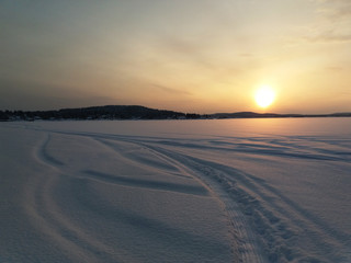 Sunset over the snowy lake