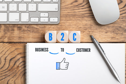 Würfel mit Acronym "B2C" und Erklärung auf Notiz als "Business to customer"