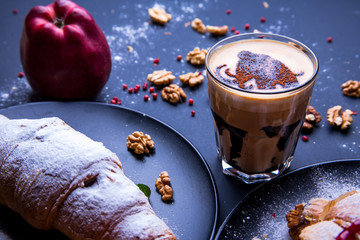 Delicious breakfast with fresh croissants and coffee served with butter and honey.