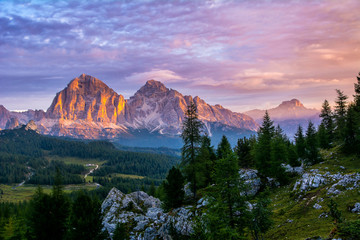 Panoramic view of famous Dolomites mountain peaks glowing in beautiful golden evening light at sunset in summer, South Tyrol, Italy. Artistic picture. Beauty of mountains world - obrazy, fototapety, plakaty