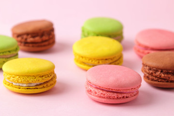 Macarons. french multicolored macaroons cakes. small french sweet cake on bright pink background. Dessert. Sweets.