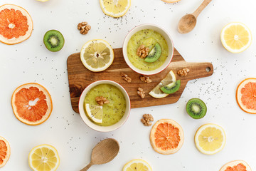 healthy food delicious smoothie with mango kiwi and lemon top view on white background