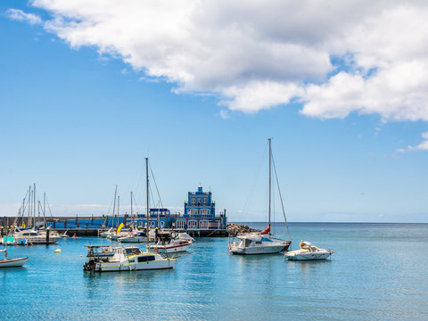 Blue harbormaster house and view over the beautiful sunny harbour of Marina del Sur in Las Galletas. Tenerife, Canary Islands, Spain. Artistic picture. Beauty world.