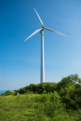Fototapeta premium Wind turbines in the mountains near the sea