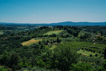 Obraz premium Chianti region in summer season. View of countryside and Chianti vineyards from San Gimignano. Tuscany, Italy, Europe. Travel. Beautiful destination. Holiday outdoor vacation trip.