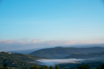 Fototapeta na wymiar Beautiful foggy landscape in Tuscany, Italy.