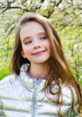 Fototapeta premium Portrait of adorable smiling little girl child outdoors in spring day