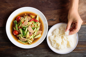 Spicy cucumber salad with steamed pork sausage and sticky rice, Thai food