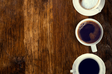 Coffee served on an old wooden table. View from above. Empty space for copying and pasting text.