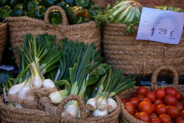 Fototapeta premium Market stall with variety of organic vegetable. Local produce at the summer farmers market in the city.