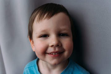naughty boy smiling at camera, portrait of a child