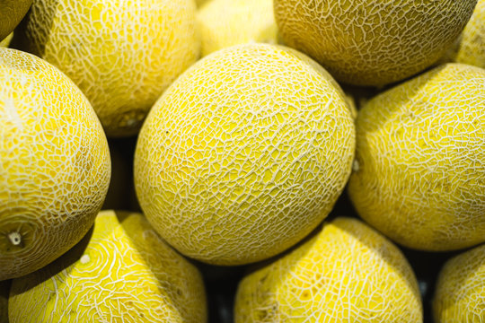 A pile of honeydew melon on display
