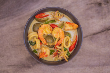 Thai food chicken green curry on dark wooden background. top view